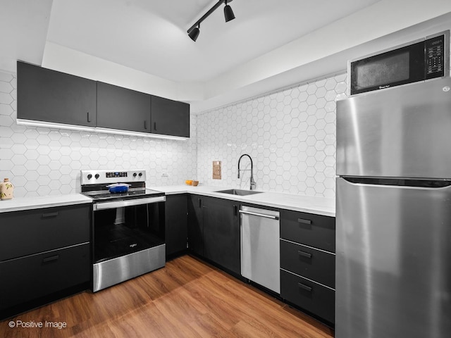 6118 N Sheridan Rd Unit 1003, Chicago, IL 60660 - kitchen featuring appliances with stainless steel finishes, a sink, light countertops, and dark cabinetry