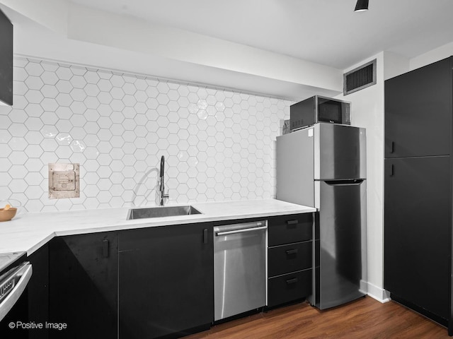6118 N Sheridan Rd Unit 1003, Chicago, IL 60660 - kitchen with stainless steel appliances, a sink, dark cabinets, and light countertops