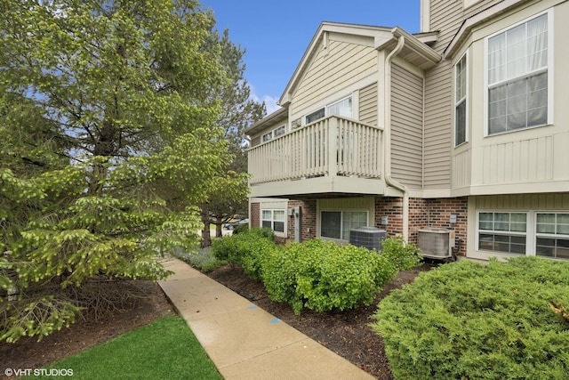 31786 N Pineview Blvd, Lakemoor, IL 60051 - view of property exterior with a balcony, cooling unit, and brick siding