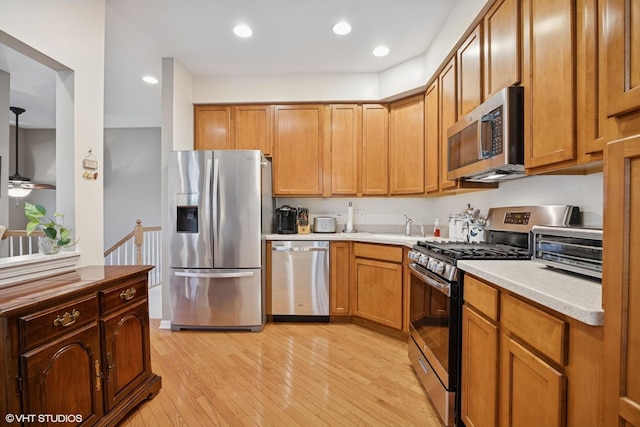 31786 N Pineview Blvd, Lakemoor, IL 60051 - kitchen with stainless steel appliances, light wood-type flooring, light countertops, recessed lighting, and a ceiling fan
