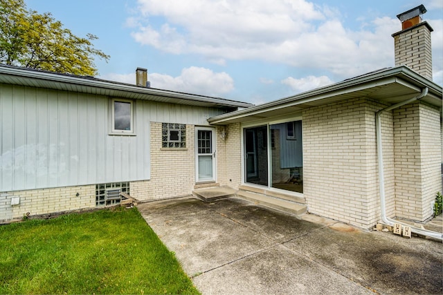 15108 Sunset Ridge Dr, Orland Park, IL 60462 - back of house featuring a chimney, a patio, brick siding, and a lawn