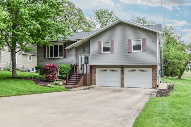 300 N Elm St, Odell, IL 60460 - split foyer home with a garage, concrete driveway, a front yard, and roof with shingles