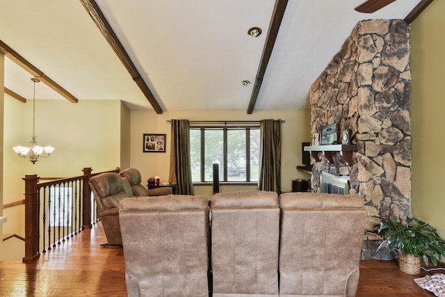 300 N Elm St, Odell, IL 60460 - living area featuring wood finished floors, beamed ceiling, a chandelier, a fireplace, and ceiling fan