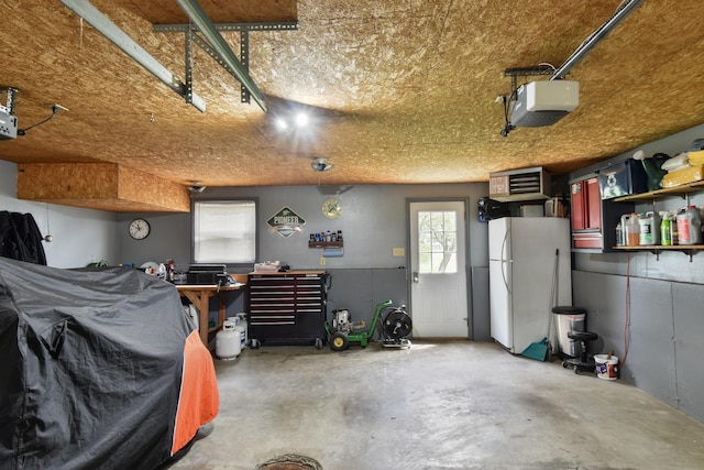 300 N Elm St, Odell, IL 60460 - garage featuring a garage door opener and freestanding refrigerator