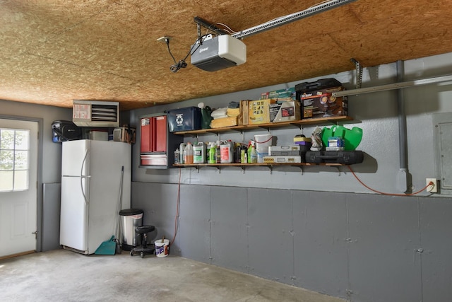 300 N Elm St, Odell, IL 60460 - garage with a garage door opener and freestanding refrigerator