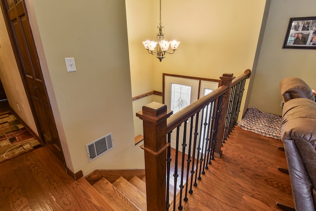 300 N Elm St, Odell, IL 60460 - stairs with a chandelier, wood finished floors, and baseboards