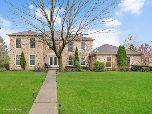 1000 Surrey Ln, Itasca, IL 60143 - view of front of house featuring french doors, a front yard, and brick siding