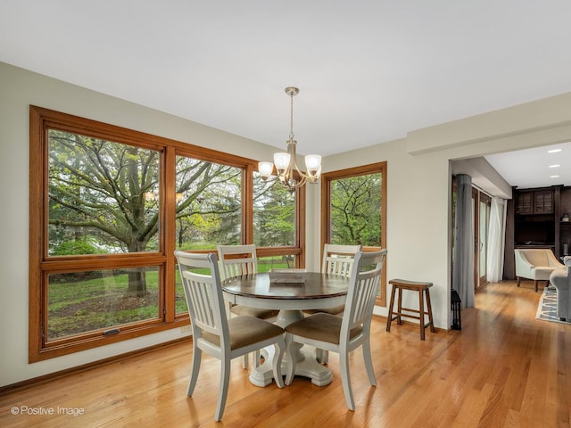 1000 Surrey Ln, Itasca, IL 60143 - dining area with a chandelier, light wood finished floors, and baseboards