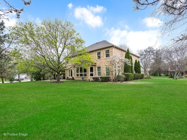 1000 Surrey Ln, Itasca, IL 60143 - back of house with brick siding and a lawn