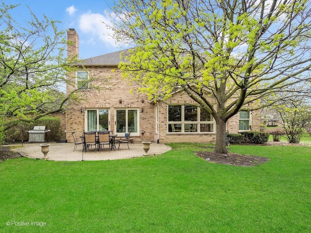 1000 Surrey Ln, Itasca, IL 60143 - rear view of property featuring a patio, brick siding, a chimney, and a lawn