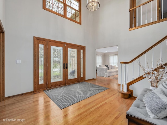 1000 Surrey Ln, Itasca, IL 60143 - entrance foyer with healthy amount of natural light, stairway, french doors, wood finished floors, and a towering ceiling
