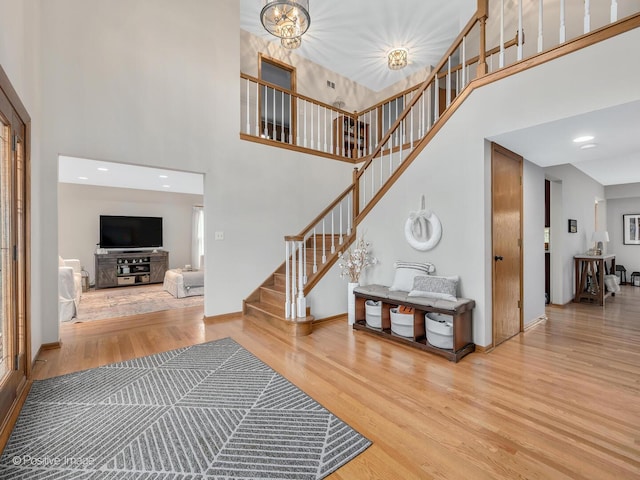 1000 Surrey Ln, Itasca, IL 60143 - staircase with a towering ceiling, wood finished floors, and baseboards
