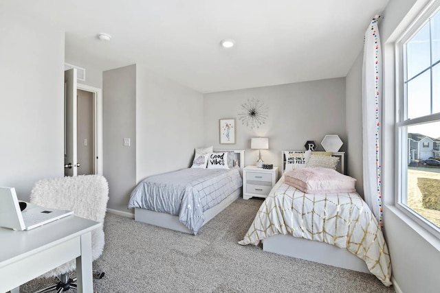 carpeted bedroom featuring baseboards