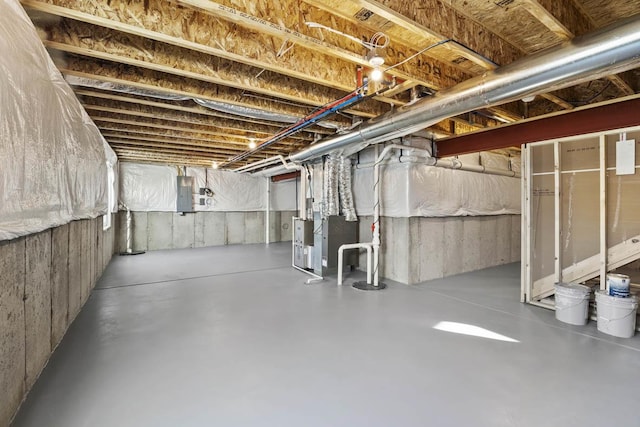 unfinished basement featuring electric panel