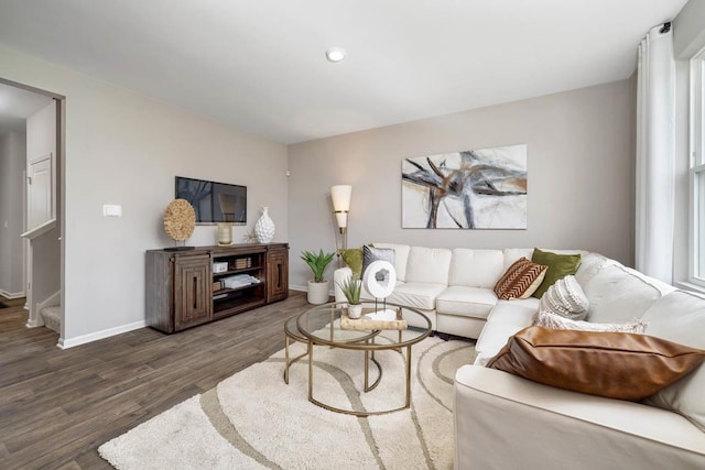 living area with baseboards, wood finished floors, stairs, and recessed lighting
