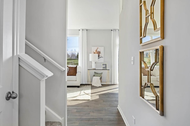 hallway with dark wood finished floors and baseboards
