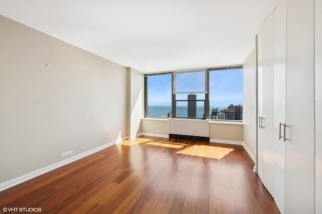 1560 N Sandburg Ter Unit 3506J, Chicago, IL 60610 - spare room featuring wood finished floors and baseboards