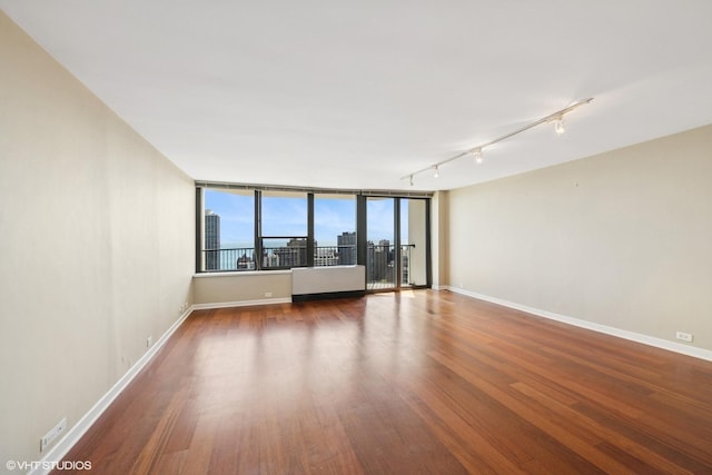 1560 N Sandburg Ter Unit 3506J, Chicago, IL 60610 - spare room with track lighting, wood finished floors, and baseboards