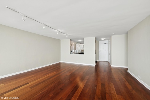 1560 N Sandburg Ter Unit 3506J, Chicago, IL 60610 - unfurnished living room featuring rail lighting, baseboards, and wood finished floors