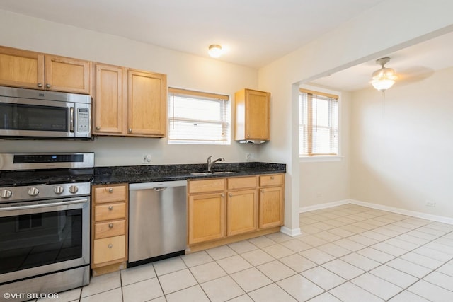 6224 N Washtenaw Ave Unit 2, Chicago, IL 60659 - kitchen with stainless steel appliances, healthy amount of natural light, a sink, and dark stone counters