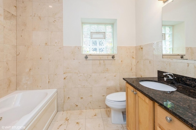 6224 N Washtenaw Ave Unit 2, Chicago, IL 60659 - full bath featuring tile walls, vanity, a bath, a wainscoted wall, and toilet