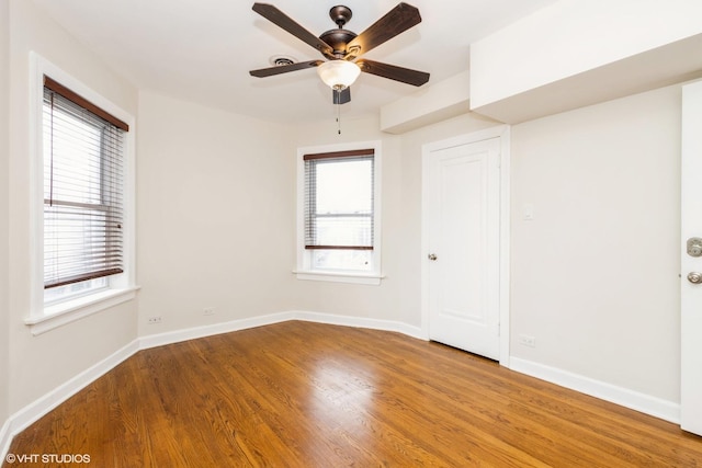 6224 N Washtenaw Ave Unit 2, Chicago, IL 60659 - unfurnished room with wood finished floors, healthy amount of natural light, and baseboards
