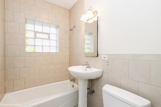 6224 N Washtenaw Ave Unit 2, Chicago, IL 60659 - bathroom featuring toilet, tile walls, and bathtub / shower combination