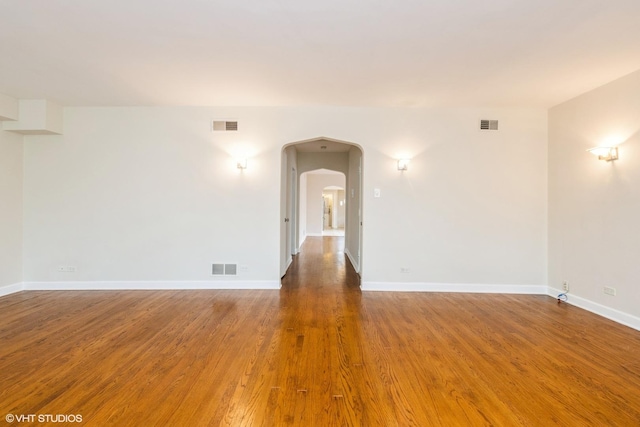 6224 N Washtenaw Ave Unit 2, Chicago, IL 60659 - unfurnished room with wood finished floors, arched walkways, and baseboards