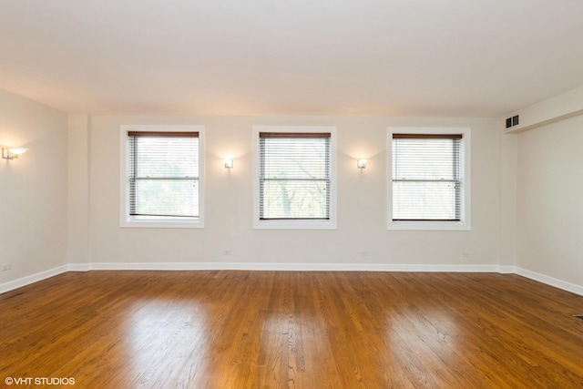 6224 N Washtenaw Ave Unit 2, Chicago, IL 60659 - spare room with healthy amount of natural light, wood finished floors, and baseboards