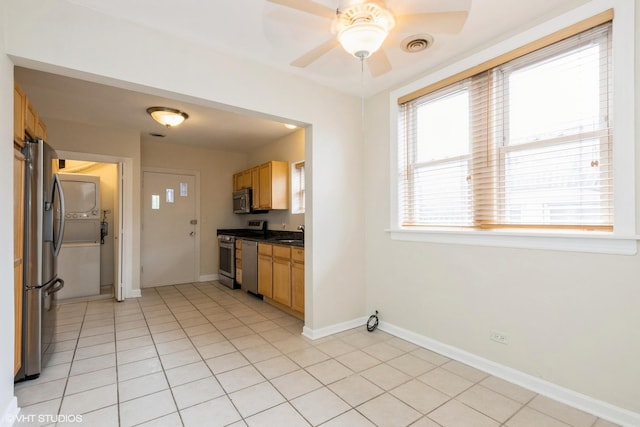 6224 N Washtenaw Ave Unit 2, Chicago, IL 60659 - kitchen featuring appliances with stainless steel finishes, ceiling fan, a sink, baseboards, and dark countertops