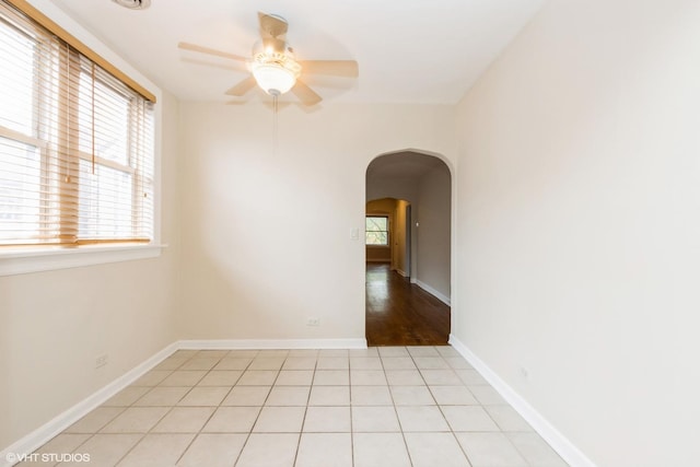 6224 N Washtenaw Ave Unit 2, Chicago, IL 60659 - unfurnished room with ceiling fan, arched walkways, and baseboards