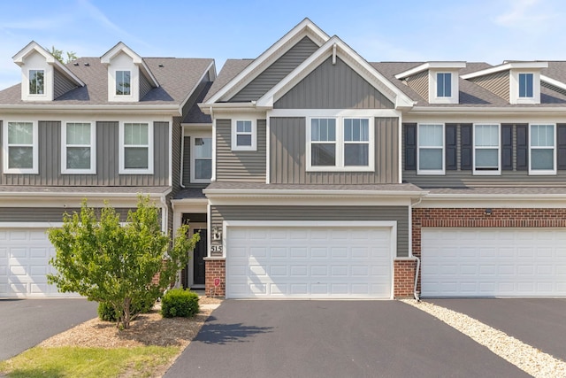 515 Watercress Dr, Aurora, IL 60504 - multi unit property featuring brick siding, asphalt driveway, board and batten siding, and an attached garage