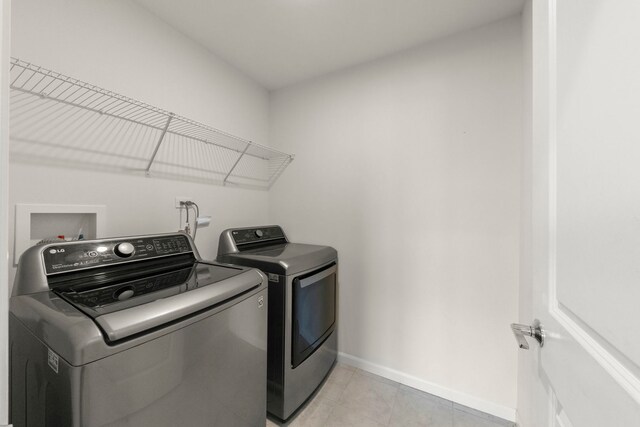 515 Watercress Dr, Aurora, IL 60504 - washroom featuring washer and clothes dryer and light tile patterned floors