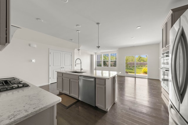 515 Watercress Dr, Aurora, IL 60504 - kitchen with appliances with stainless steel finishes, dark wood-type flooring, a kitchen island with sink, recessed lighting, and pendant lighting