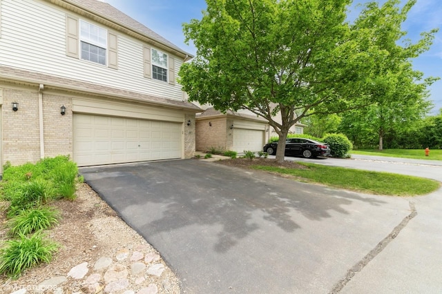 1237 Bradley Cir, Elgin, IL 60123 - view of front of property with brick siding, a garage, and asphalt driveway