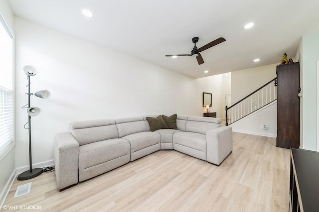 1237 Bradley Cir, Elgin, IL 60123 - living area featuring a ceiling fan, light wood-style floors, baseboards, stairway, and recessed lighting