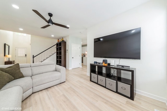 1237 Bradley Cir, Elgin, IL 60123 - living room with a ceiling fan, light wood-style flooring, stairway, baseboards, and recessed lighting