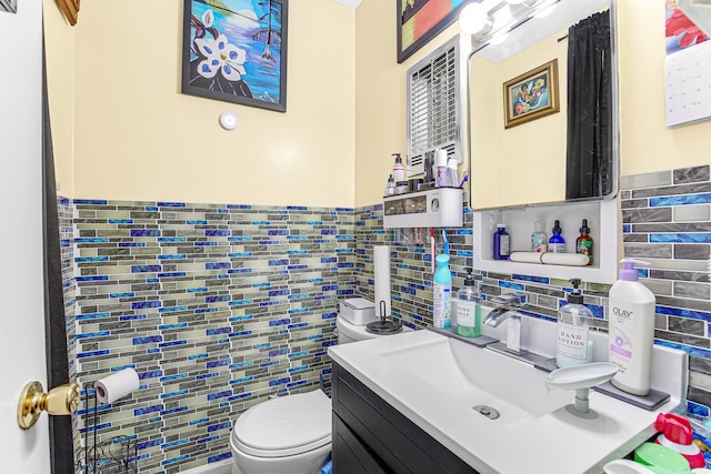 336 Niagara St, Park Forest, IL 60466 - half bathroom with tile walls, toilet, vanity, and backsplash