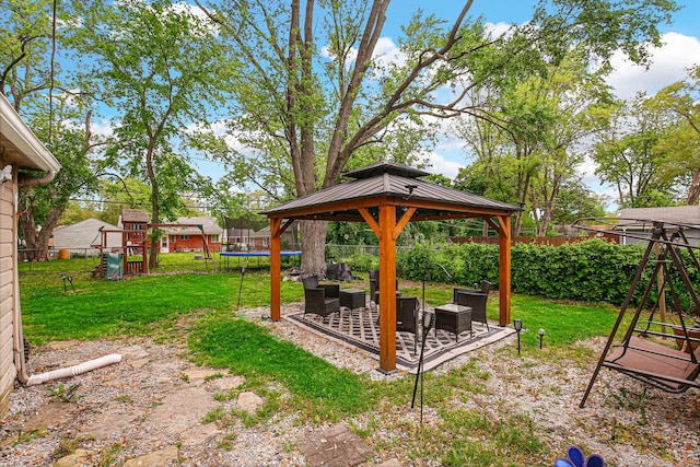 336 Niagara St, Park Forest, IL 60466 - view of yard with a trampoline, a playground, an outdoor hangout area, a gazebo, and a patio area