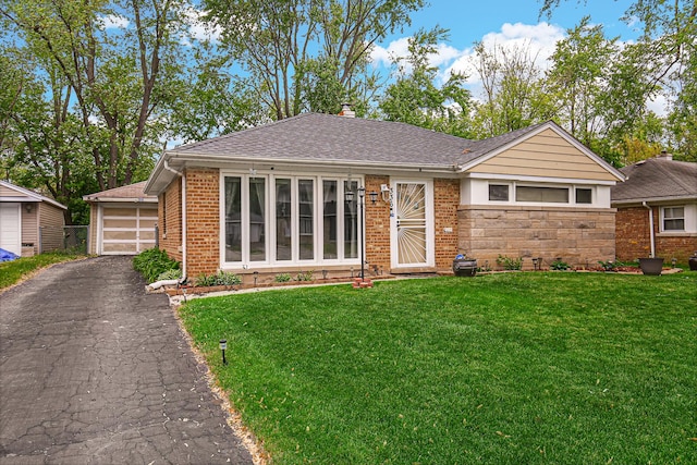 336 Niagara St, Park Forest, IL 60466 - view of front of home with a front lawn, brick siding, a detached garage, and roof with shingles