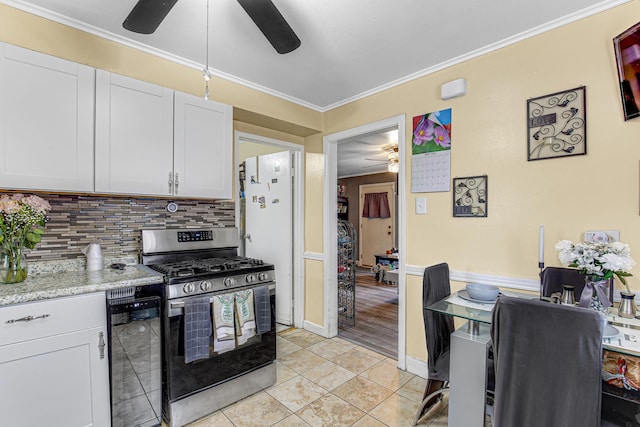 336 Niagara St, Park Forest, IL 60466 - kitchen featuring stainless steel range with gas stovetop, a ceiling fan, tasteful backsplash, white cabinets, and crown molding