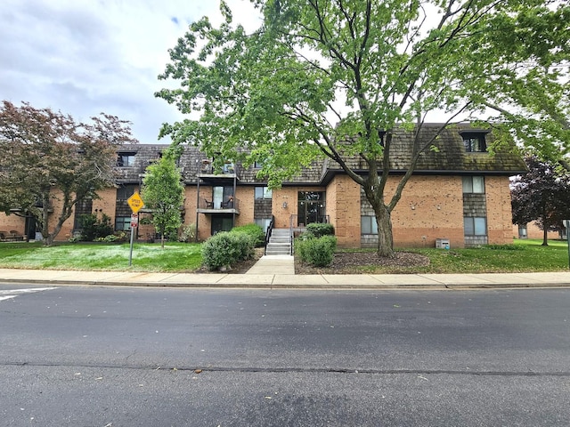 2 Oak Creek Dr Unit 3207, Buffalo Grove, IL 60089 - view of front facade with brick siding and mansard roof