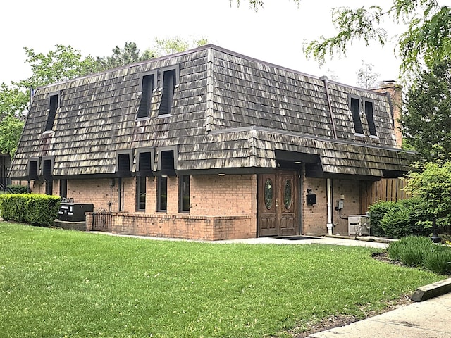 2 Oak Creek Dr Unit 3207, Buffalo Grove, IL 60089 - view of front of house with brick siding, mansard roof, and a front yard