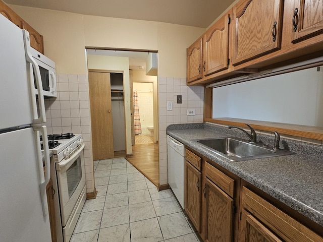 2 Oak Creek Dr Unit 3207, Buffalo Grove, IL 60089 - kitchen featuring white appliances, tile walls, a sink, dark countertops, and brown cabinets