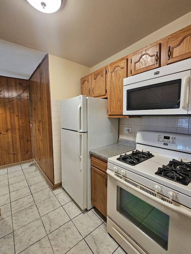 2 Oak Creek Dr Unit 3207, Buffalo Grove, IL 60089 - kitchen with white appliances, light countertops, brown cabinets, and wood walls