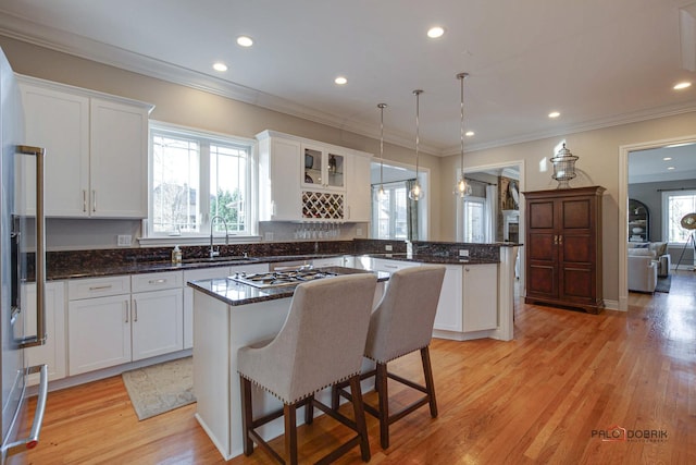 38868 Oakcrest Ln, Wadsworth, IL 60083 - kitchen featuring white cabinets, a sink, a kitchen island, light wood finished floors, and a peninsula
