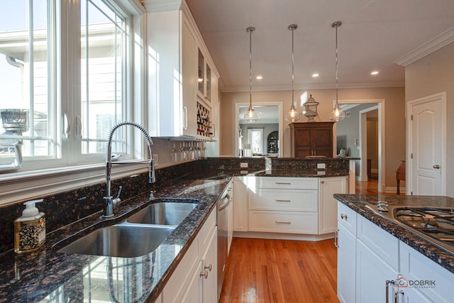 38868 Oakcrest Ln, Wadsworth, IL 60083 - kitchen featuring a sink, white cabinetry, decorative light fixtures, appliances with stainless steel finishes, and ornamental molding