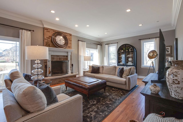 38868 Oakcrest Ln, Wadsworth, IL 60083 - living room with a brick fireplace, recessed lighting, wood finished floors, ornamental molding, and baseboards