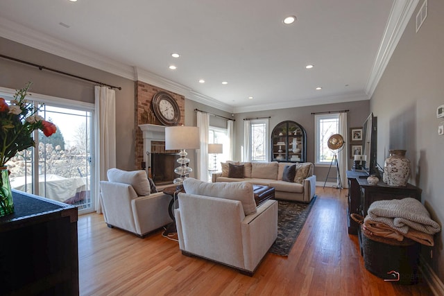 38868 Oakcrest Ln, Wadsworth, IL 60083 - living area with light wood finished floors, recessed lighting, a brick fireplace, crown molding, and baseboards