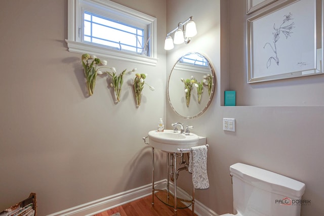38868 Oakcrest Ln, Wadsworth, IL 60083 - bathroom with toilet, plenty of natural light, baseboards, and wood finished floors